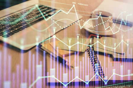 Multi exposure of forex graph drawing and desktop with coffee and items on table background. Concept of financial market tradingの写真素材