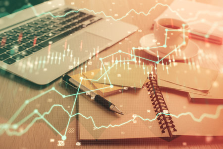 Multi exposure of forex graph drawing and desktop with coffee and items on table background. Concept of financial market tradingの写真素材