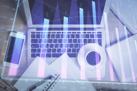 Stock market chart and top view computer on the table background. Double exposure. Concept of financial analysis.の写真素材