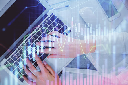 Double exposure of woman hands working on computer and forex chart hologram drawing. Top View. Financial analysis concept.の写真素材