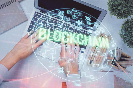 Double exposure of woman hands working on computer and blockchain theme hologram drawing. Top View. bitcoin cryptocurrency concept.の写真素材