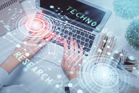 Double exposure of woman hands working on computer and data theme hologram drawing. Top View. Technology concept.の写真素材