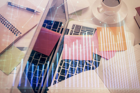 Multi exposure of financial chart drawing over table background with computer. Concept of research and analysis. Top view.の写真素材