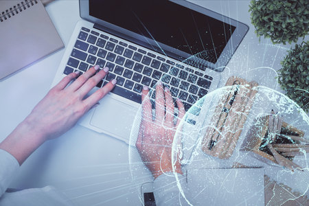 Double exposure of woman hands working on computer and social network theme hologram drawing. Top View. People connection concept.の写真素材