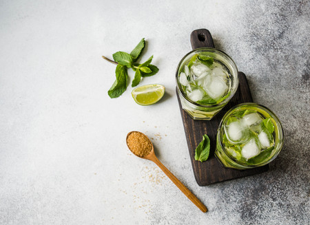 Mojito cocktail. Alcohol cocktails with Rum, lime, mint, ice cubes and brown sugarの写真素材