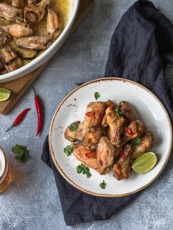 Fried chicken wings with lime, chili and cilantroの写真素材