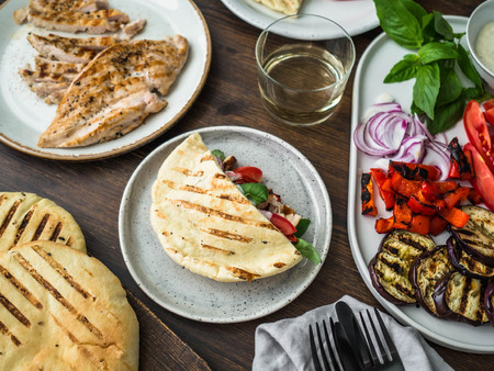 Pita with grilled vegetables, paprika, raw onion, eggplant, tomato, chicken and basil with sauceの写真素材
