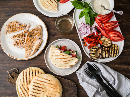 Pita with grilled vegetables, paprika, raw onion, eggplant, tomato, chicken and basil with sauceの写真素材