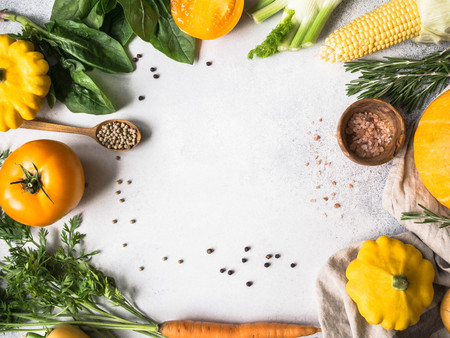 Vegetable background. Fresh harvest of vegetables and spices frame on Gray background with an open space for inscriptions. Top viewの写真素材