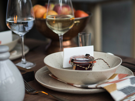 Table setting for Thanksgiving. Serving with a personal compliment in the form of small jars with...