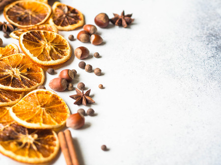 Bright Christmas or New Year - dry orange slices and spices. Ingredients for making winter seasonal drink - mulled wine.の写真素材