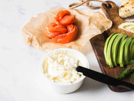 Ingredients for preparation sandwiches with cream cheese, salmon, avocado on grilled toasts on white marbleの写真素材