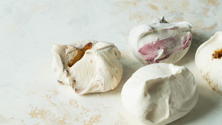 Sweet dessert - meringue with different filling on a textureの写真素材