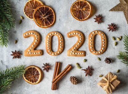 Ginger biscuits of the form of numbers and 2020 new year ginger cookies on grey