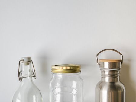 Items for purchase or storage of various liquids. Glass bottle, metal bottle and glass jar on a...