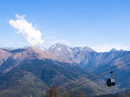 glazed cabin of a funicular on the background of mountains and blue skyの写真素材
