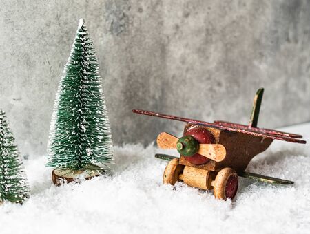 Christmas composition with a wooden vintage airplane and Christmas tree in snowの写真素材