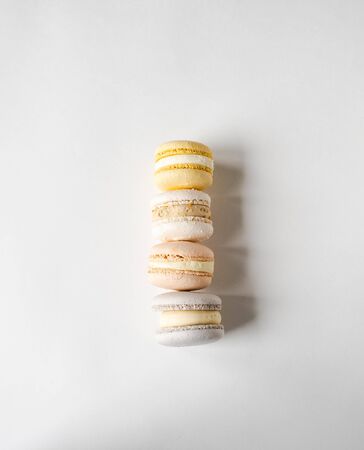 Stack of four fresh french pastel colorful macarons on white background. top viewの写真素材