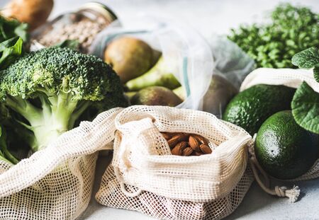 Healthy vegan ingredients for cooking. Various clean wholesome vegetables and herbs in woven bags. Products from the market without plastic. Zero waste conceptの写真素材