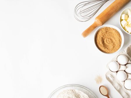 Frame of various baking ingredients on white
