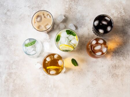 Flat lay of various refreshing drinks in glasses with ice.の写真素材