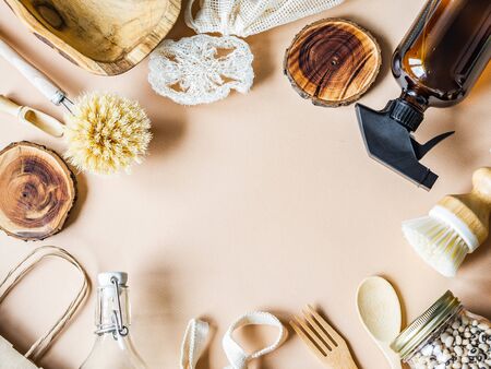 Zero waste concept. Flat lay eco-friendly set. Frame of brushes, bags, bottles and jar on a beige background. Top viewの写真素材