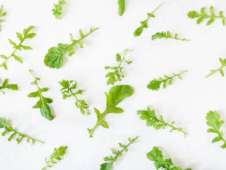 Arugula pattern isolated on white background. Composition made of arugula leaves. Flat lay, top viewの写真素材