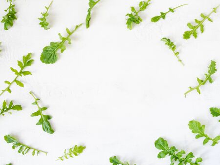 Arugula pattern isolated on white background. Composition made of arugula leaves. Flat lay, top viewの写真素材