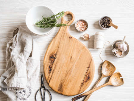 Kitchen cooking flat lay. Various ingredients, kitchen utensils and wood board for placing your text...