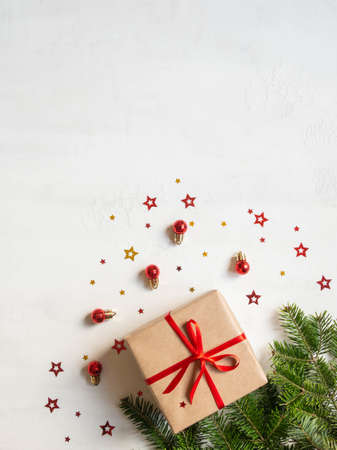 Christmas or new year gift, festive decor and fir tree branches on texture white background. Top view, flat lay. Copy spaceの写真素材
