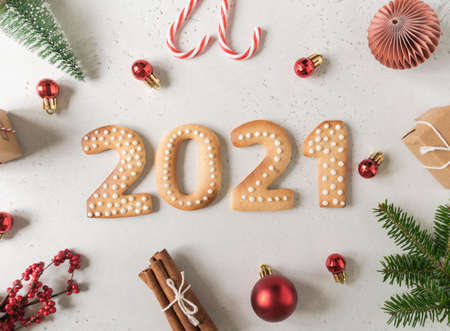 Gingerbread cookies in the form of numbers, gingerbread New Year 2021 and festive decor on gray background. Top view. Flat layの写真素材