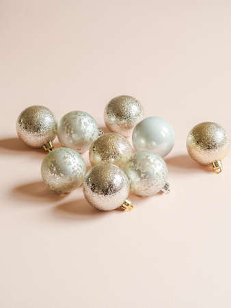 Composition of silver textured christmas balls of on a pastel peach background. Front view. Copy spaceの写真素材