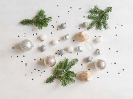 Christmas or new year flat lay confetti and silver christmas balls on white texture background. top...
