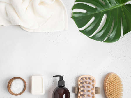 Border of brown bottle mockup for cosmetic products and various bath accessories. top view. copy...