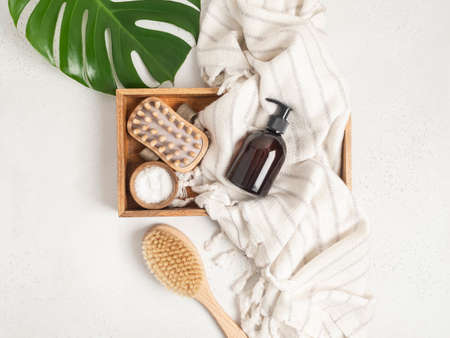 Brown bottle mockup for bathing products in the bathroom, spa shampoo, shower gel, liquid soap on cotton towel and various accessories flat lay. Top view. copy spaceの写真素材