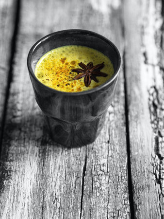 Golden milk in cup. Creative concept of the year 2021 ultimate gray and illuminating yellow. Copy spaceの写真素材