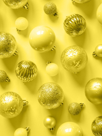 Flat lay of various christmas balls of on a pastel peach background. Top view.の写真素材