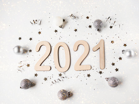 Flat lay white New year composition - numbers 2021 and confetti on a white background. Top viewの写真素材