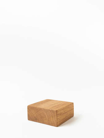 Empty wood cube podium for products presentation. Display stand on white background. Front view. Copy space.の写真素材