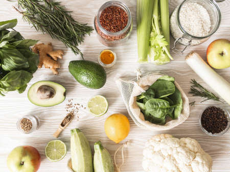 Fresh raw vegetables, fruits, grains and spices on wood light background. Cooking background, Top viewの写真素材