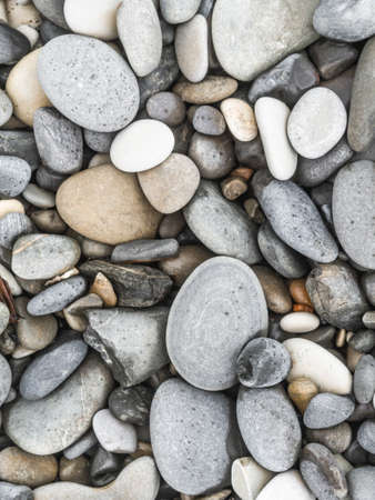 Pebbles of various colors on the sea coast. Natural background.の写真素材