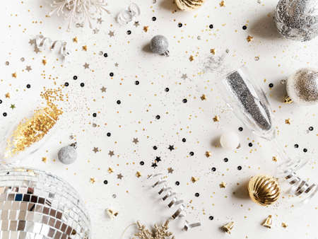 Flat lay of Christmas or New Year, gold and silver party season decorations on white background. Holiday and invitation background. Christmas or new year wish layout. Top viewの写真素材