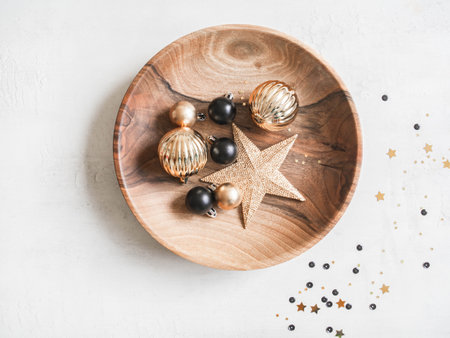 Christmas or New Year background - wooden plate with various Christmas balls and gold star on white background. Decorations for home, holiday decor. Flat lay. Top view,の写真素材