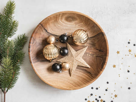 Christmas or New Year background - wooden plate with various Christmas balls and gold star on white background. Decorations for home, holiday decor. Flat lay. Top view,の写真素材