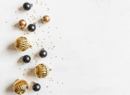 Greeting card - happy new year and Merry Christmas, gold stars glitter and black and gold christmas balls on white textured background. Minimal holiday concept. Top view. Flat layの写真素材