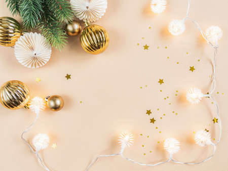 Flat lay of Christmas or New year border. Christmas balls, garland, season decoration on beige background. Holiday and invitation mockup. Christmas or new year wish layout. Copy space. Top viewの写真素材