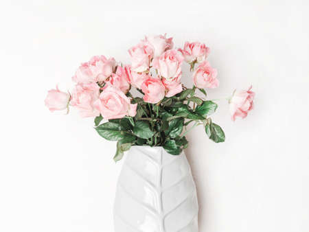 Bouquet of pink roses in ceramic vase. Floral still life with roses on white background. Front viewの写真素材