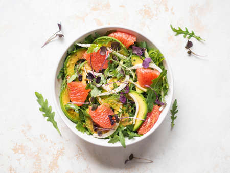 Grapefruit, avocado, arugula, sprouts and fennel salad in white bowl. Top viewの写真素材