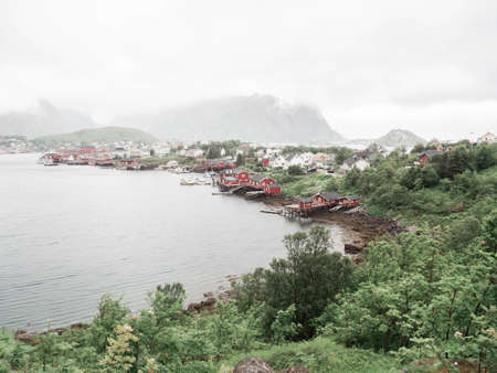 View on red traditional Norwegian house on the coast fortified by piles. Norwegian landscapeの写真素材