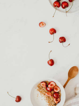 Healthy breakfast with greek yogurt, granola and cherry on bright white background, Health care,...